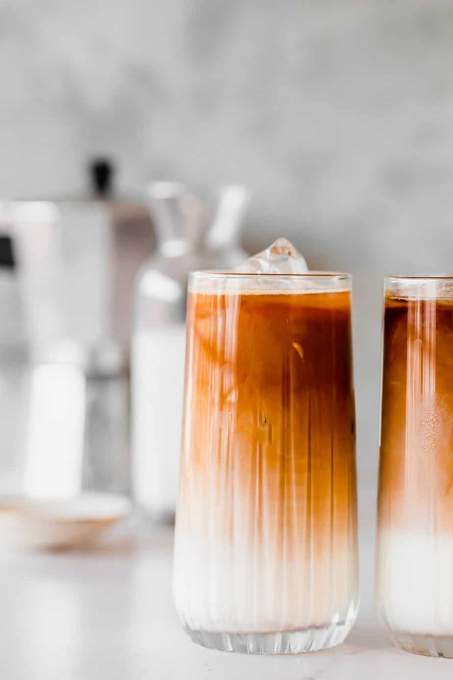 An Almond Milk Iced Coffee in serving glass with ice cubes.