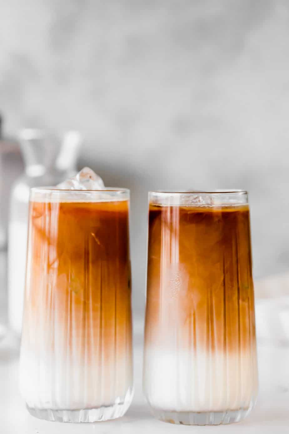 Two Almond Milk Iced Coffees on white background.