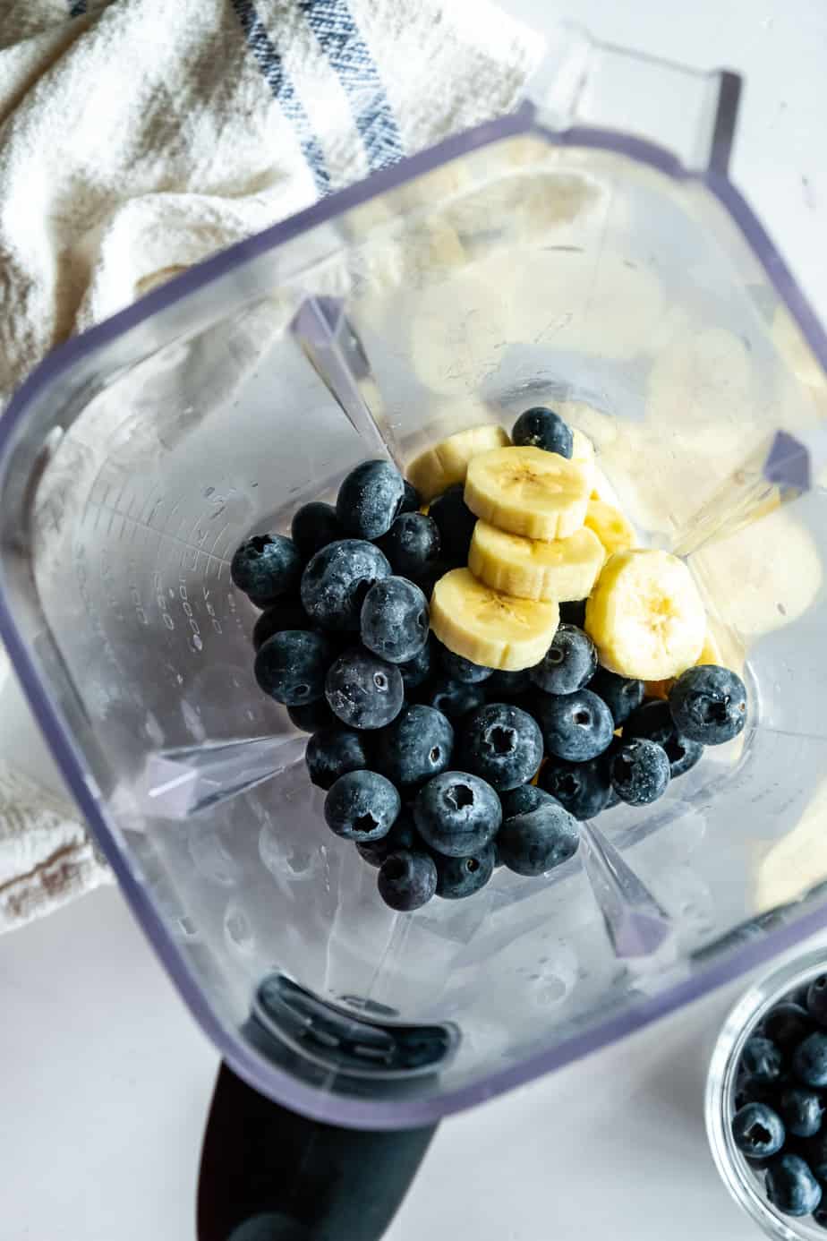 Bananas and blueberries in a blender.