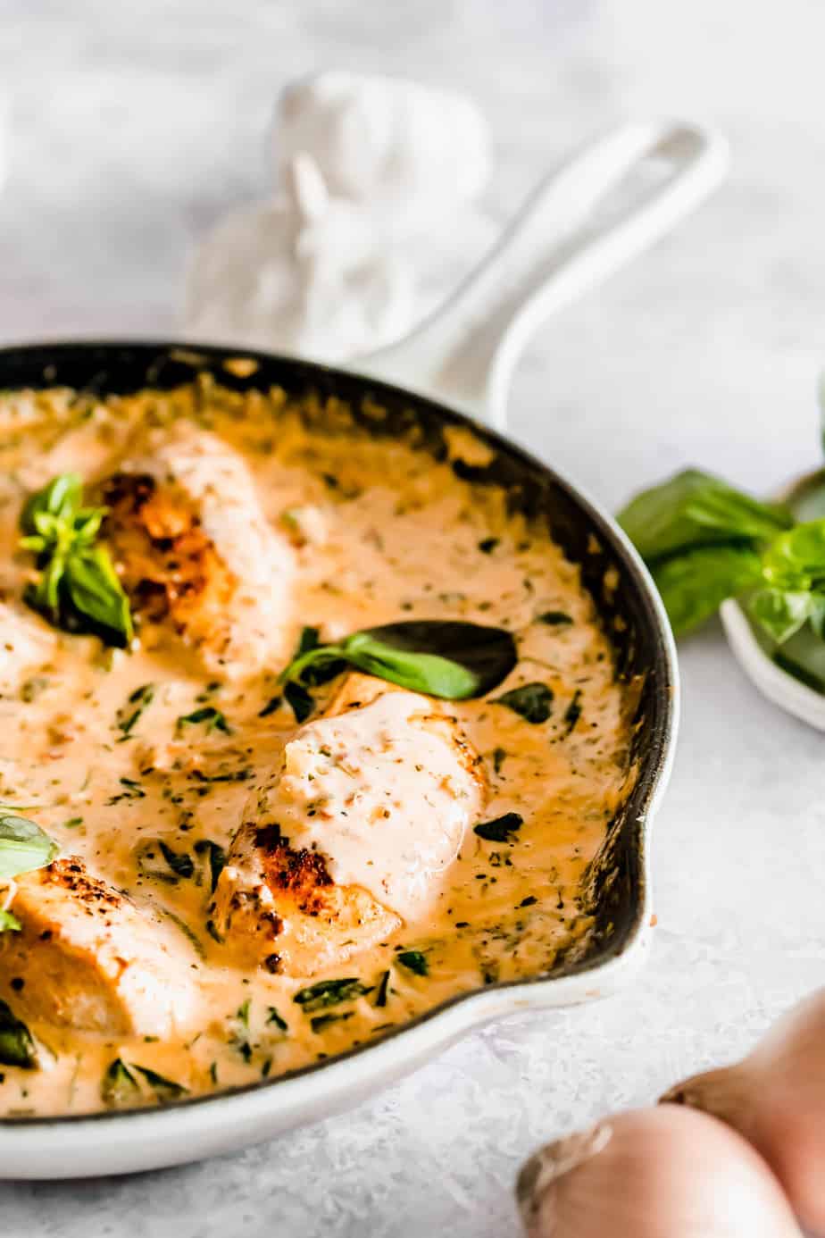 Creamy sauce and chicken in a pan.