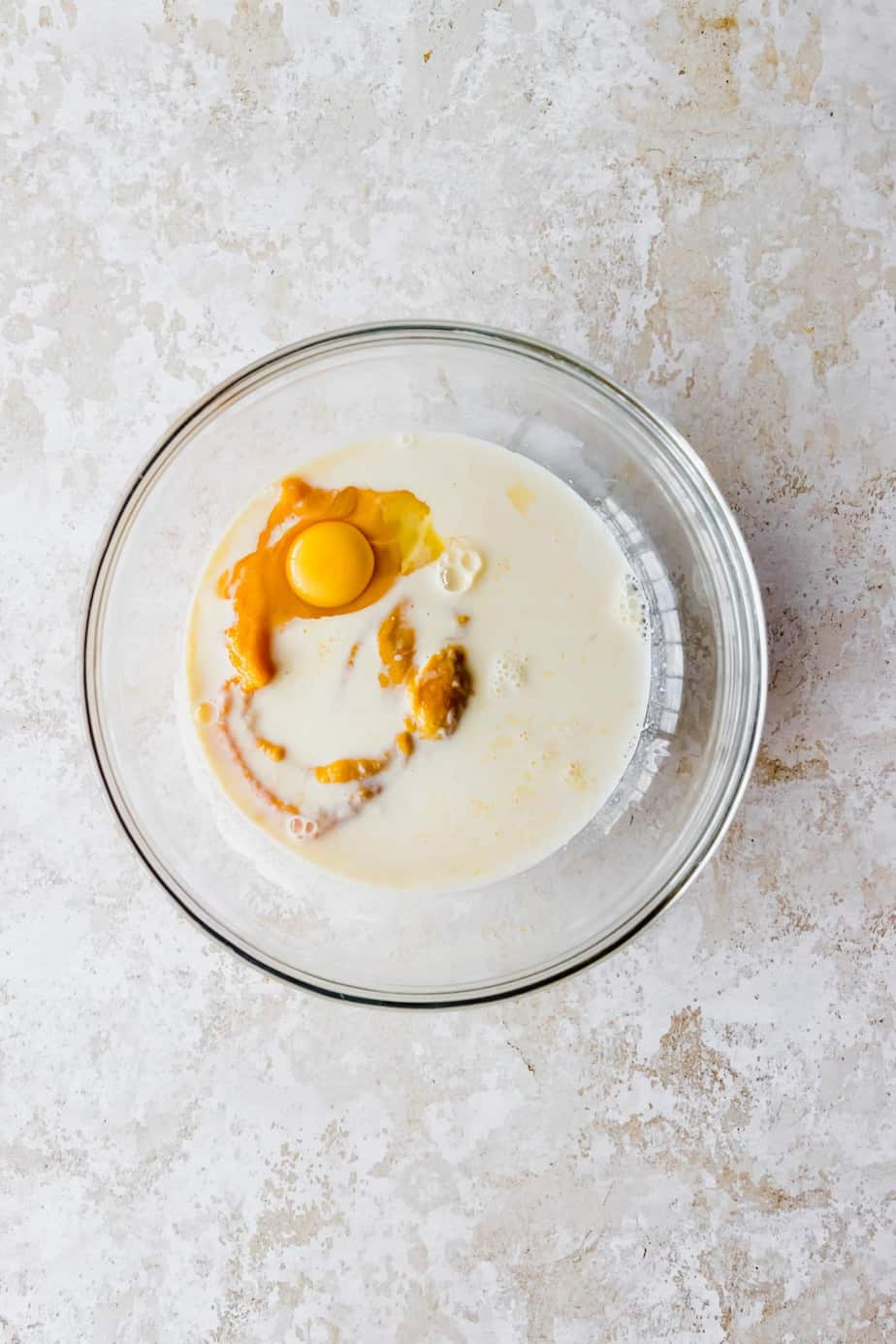 Pumpkin puree, buttermilk, eggs and melted butter combined in a large mixing bowl.