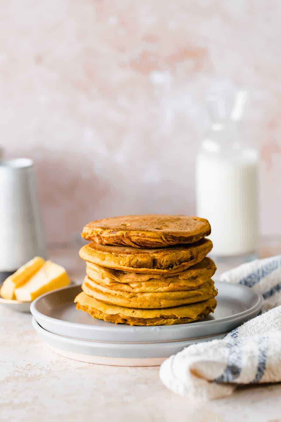 A stack of pancakes on a grey plate 