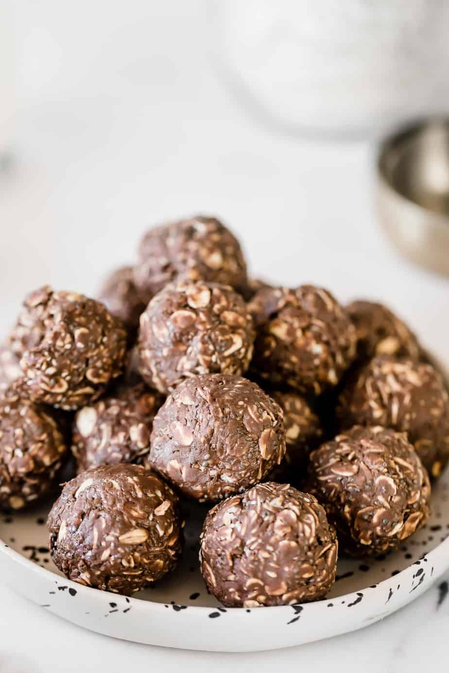 A white plate filled with Nutella energy balls with oats.