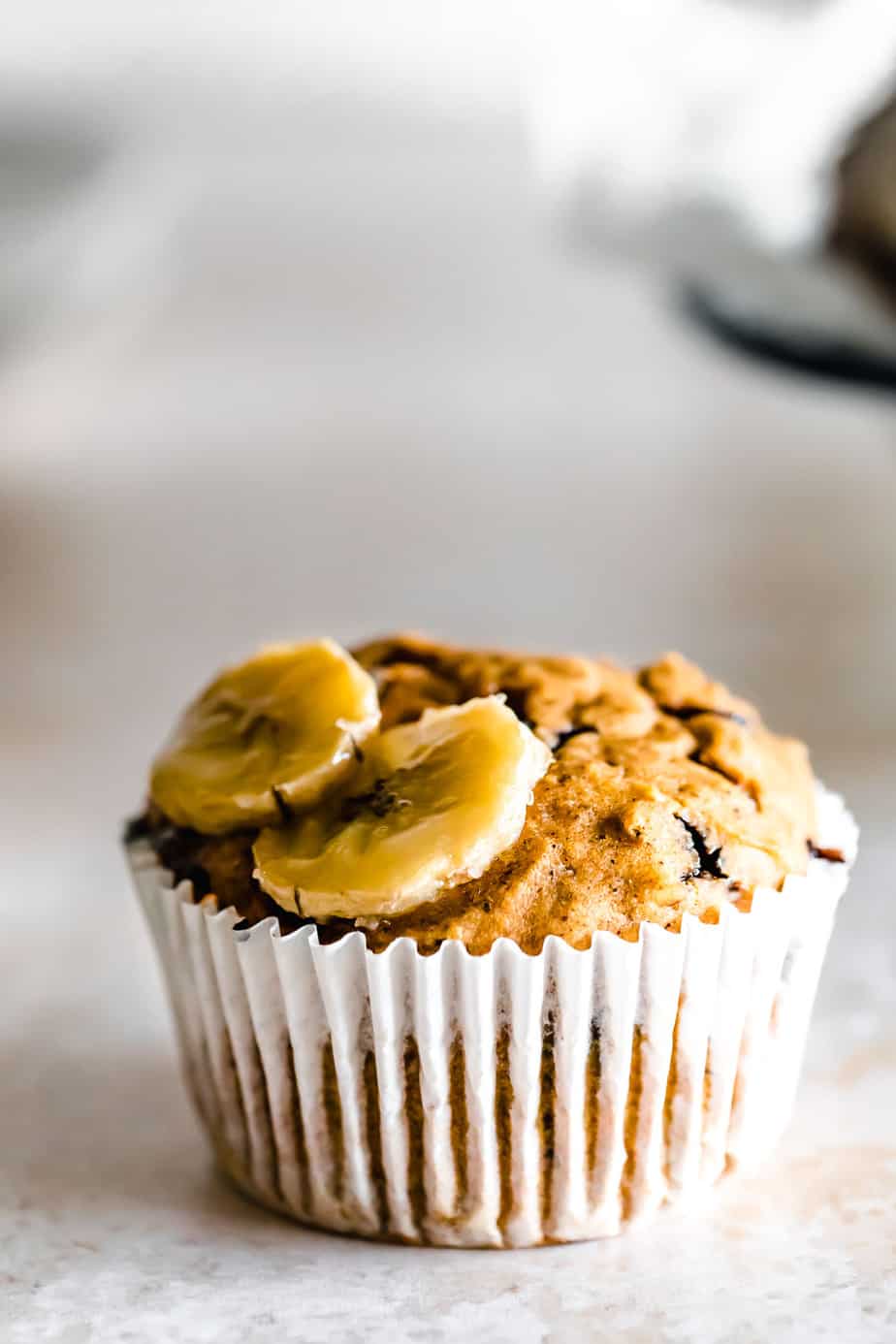 A muffin with sliced bananas on top