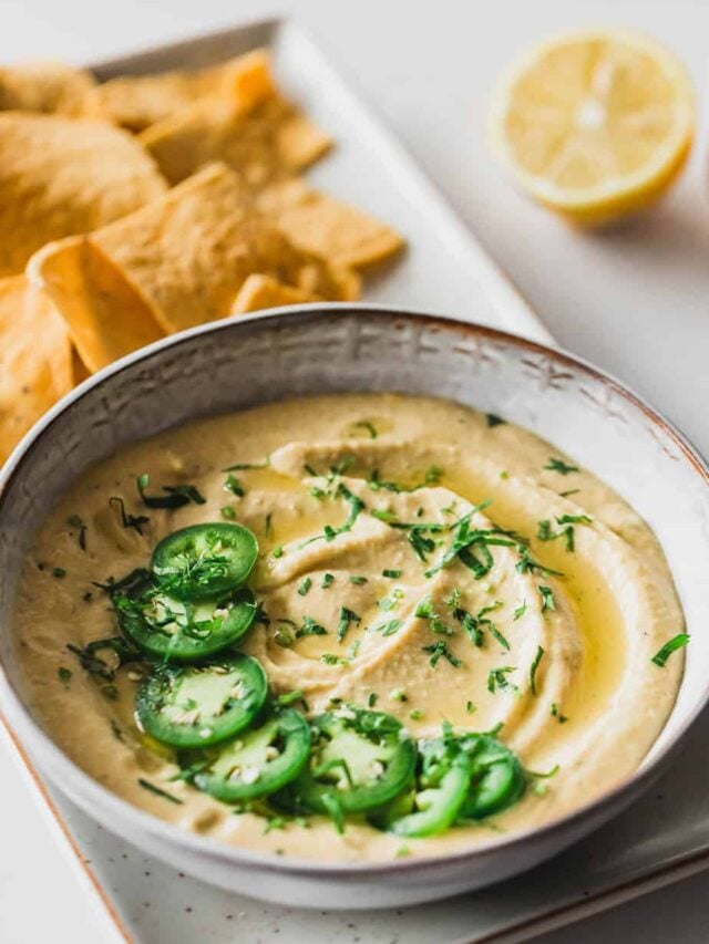 Jalapeno hummus served with fresh herbs and tortilla chips.