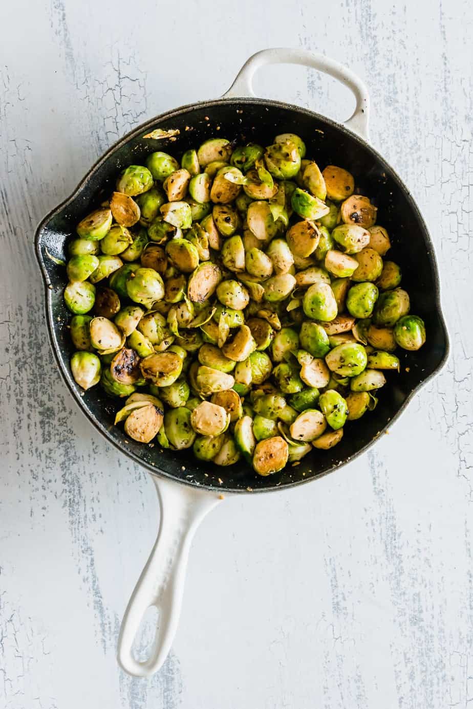 Cooked Brussels sprouts in a skillet.