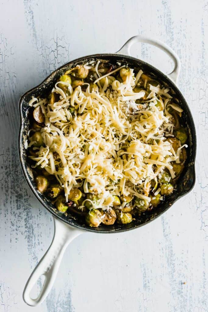 Keto Brussels Sprouts with Bacon & Cheese in a skillet