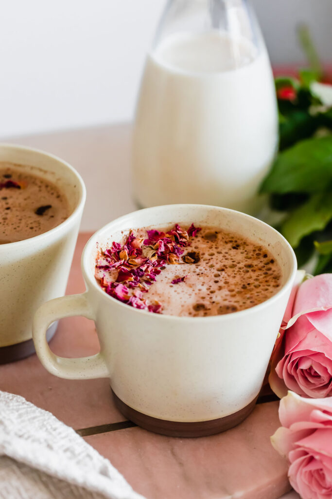 Maca latte in brown mug on pink marble
