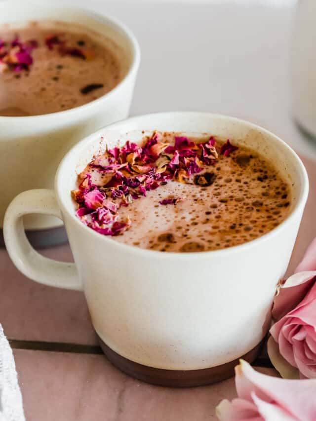 A mug of hot chocolate with frothed creamer on top.