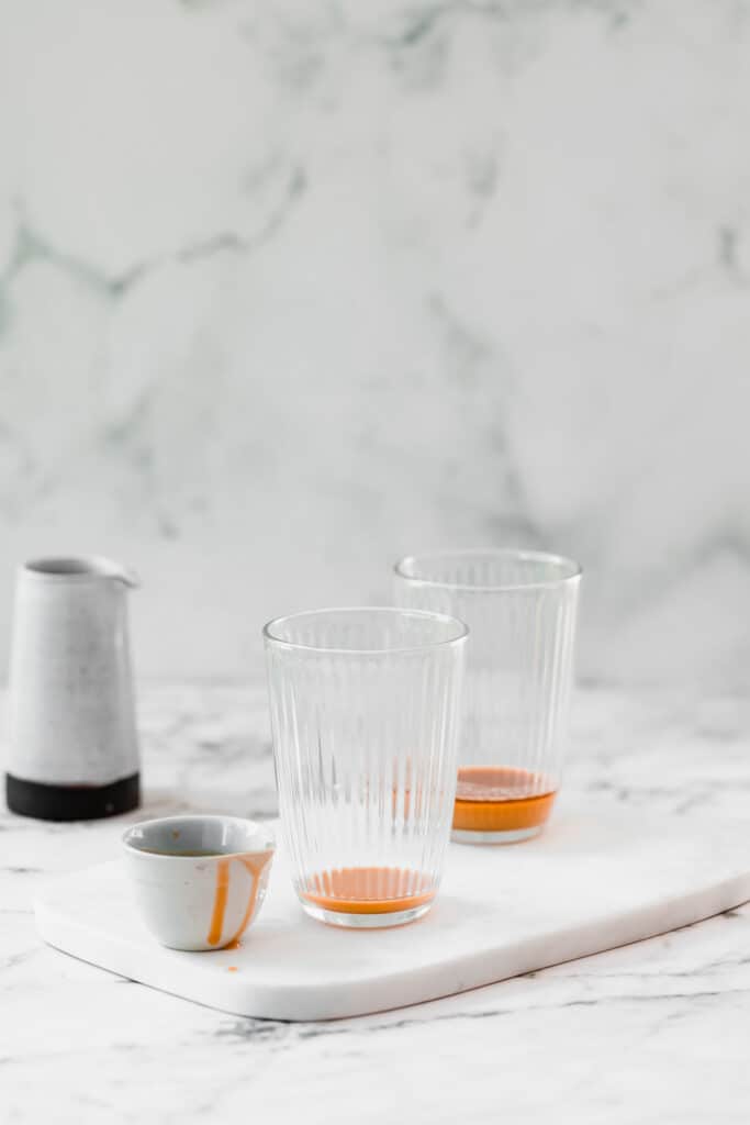 caramel syrup in glass with marble background