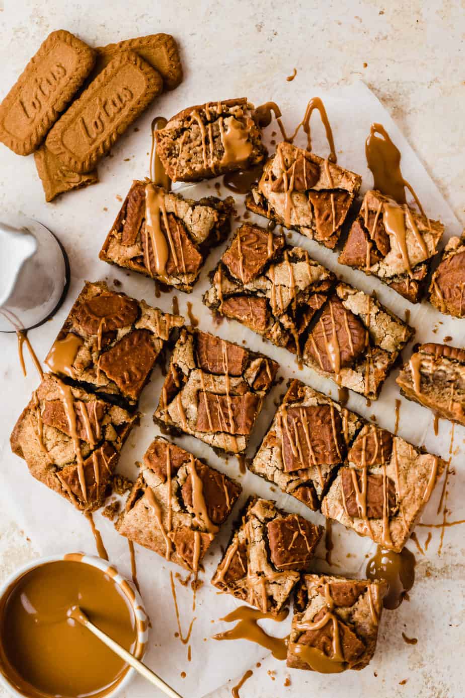Biscoff Blondies with chunks of Lotus Biscuits and a drizzle of caramel sauce.