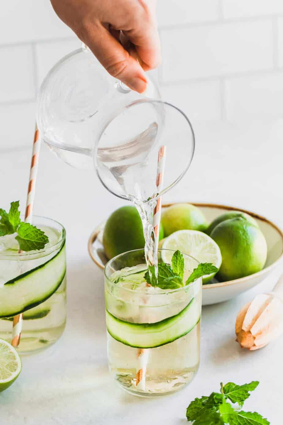 cucumber gin mojitos with fresh limes and mint leaves