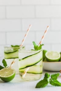 cucumber gin mojitos with fresh limes and mint leaves
