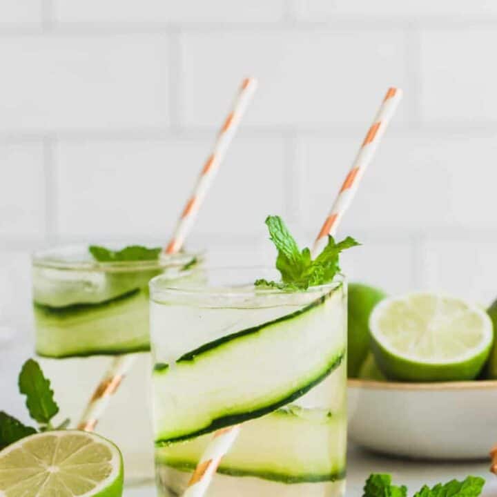 cucumber gin mojitos with fresh limes and mint leaves