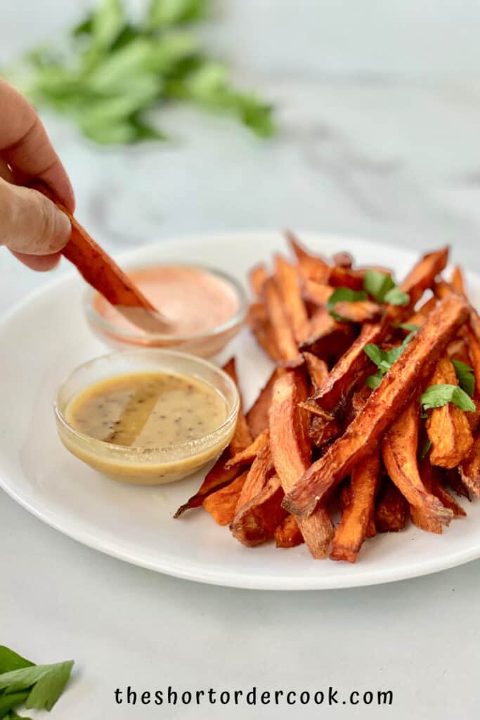 Deep fried sweet potato fries on white plate