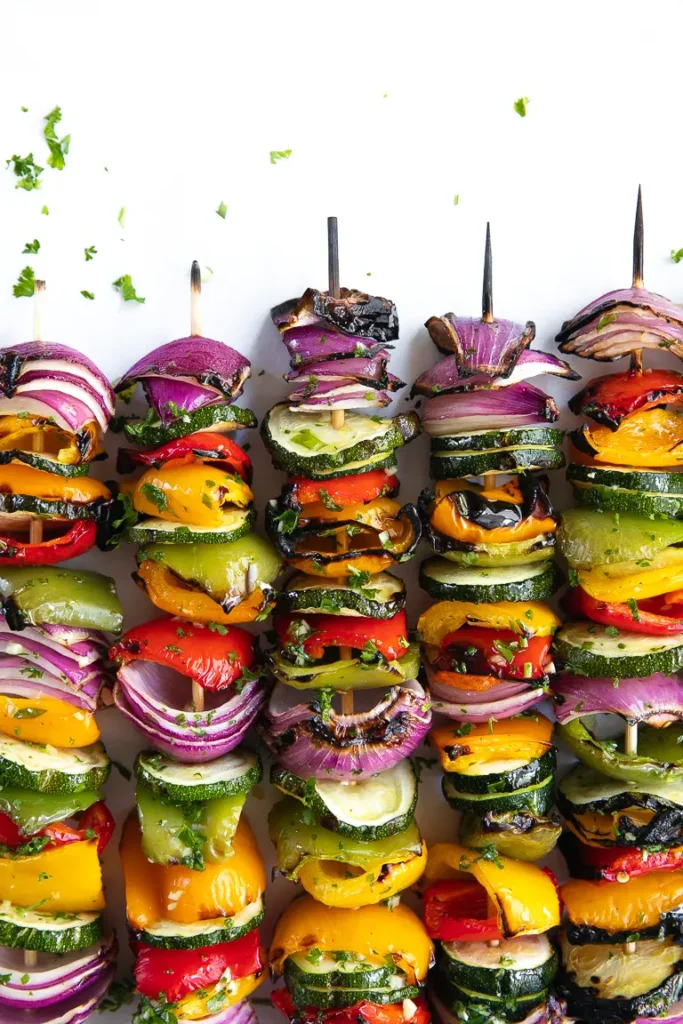 grilled vegetable skewers on white background