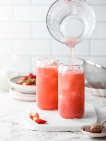 two glasses with cold strawberry drink