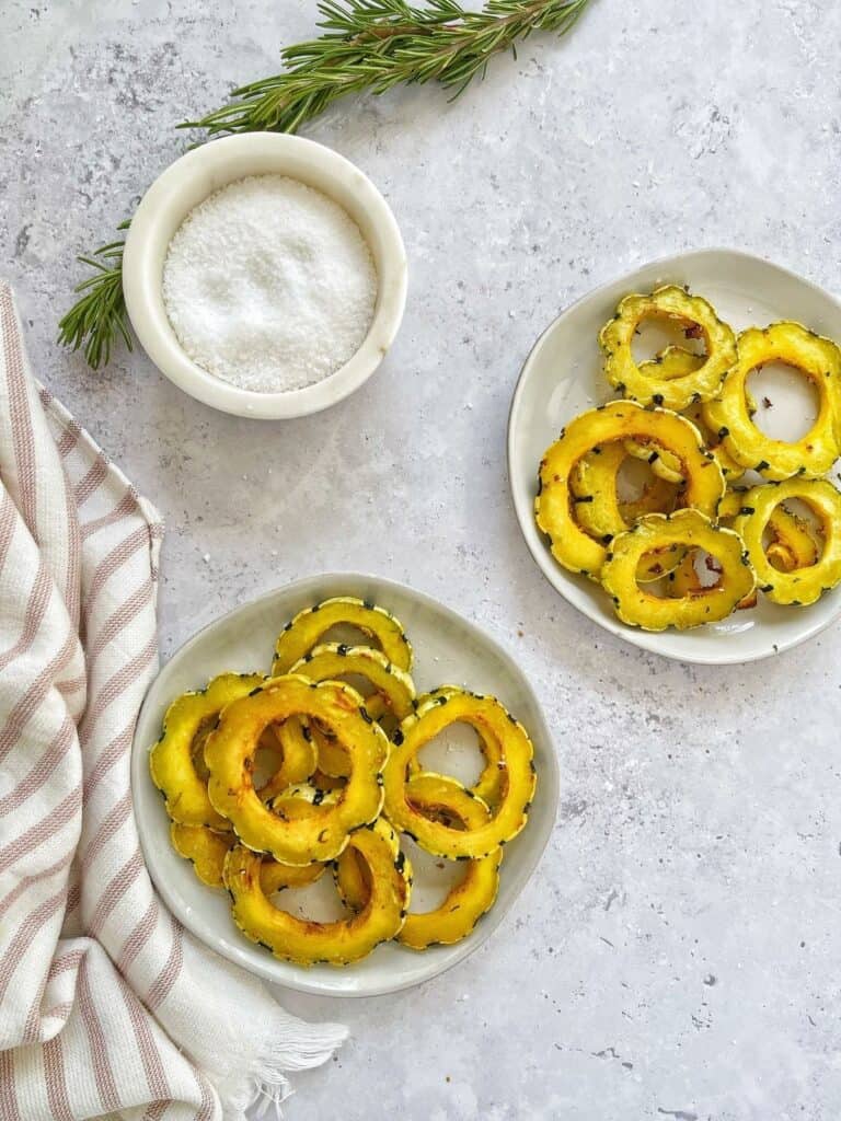 air fryer squash on two white plate on grey background