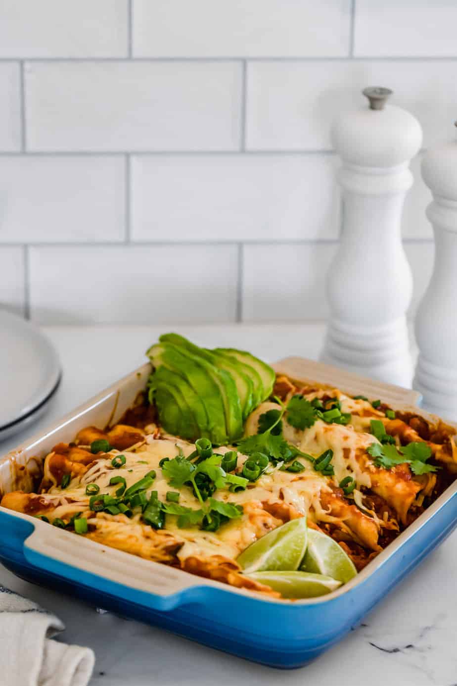 A baking dish filled with Mexican tacos.