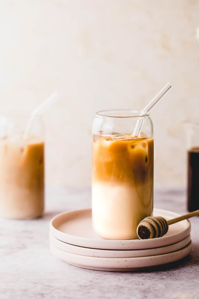 pink plates with tall glass filled with cold brew and almond milk