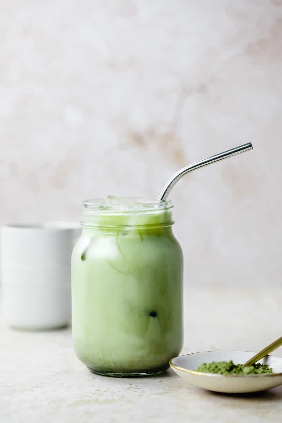 An iced vanilla matcha with a silver straw.