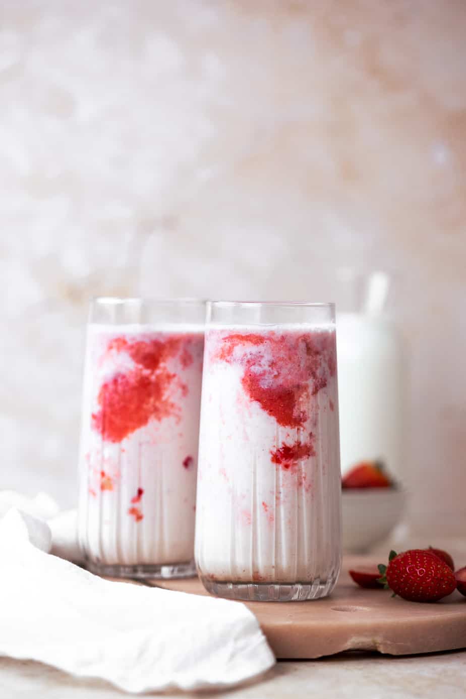 korean strawberry milk in two glasses with pink marble