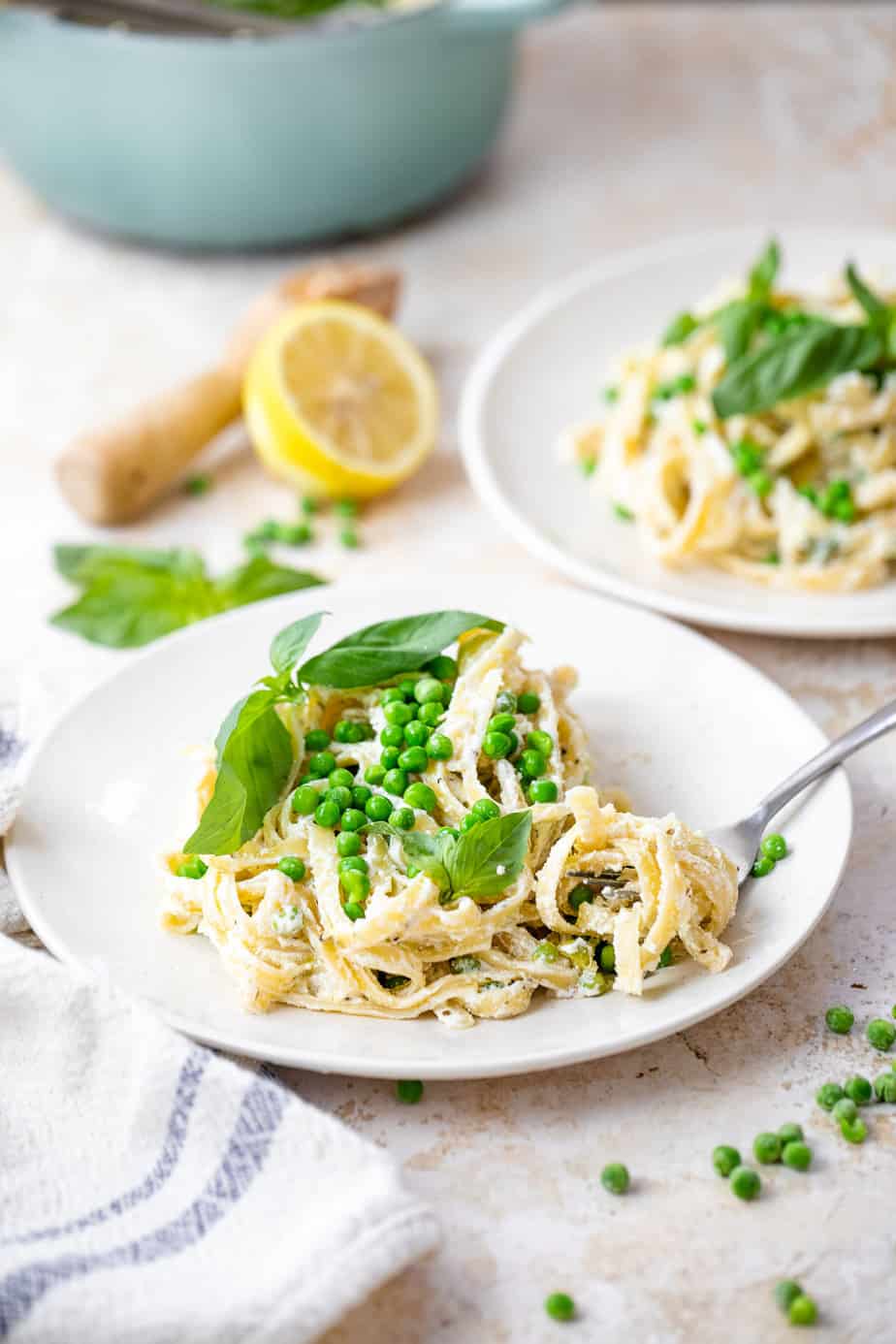 Lemon and Ricotta Cheese Pasta in a bowl with fresh basil and peas on top.