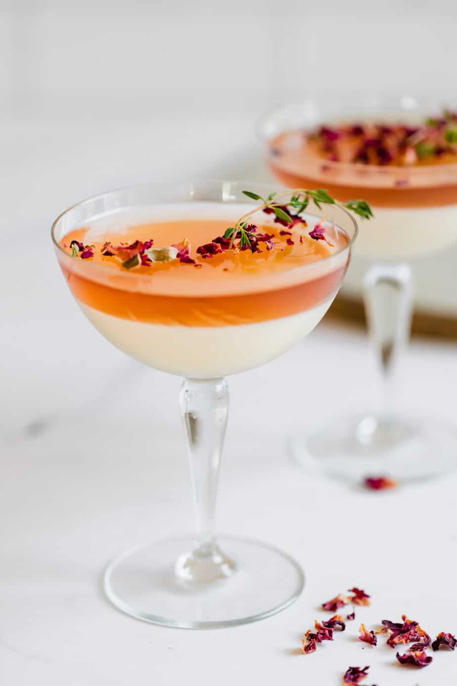 A panna cotta with jelly topping in a serving glass.