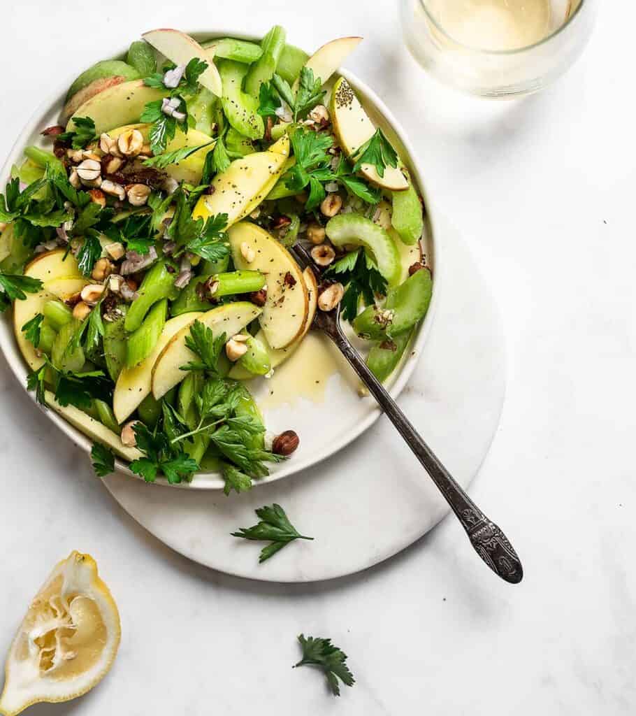 salad with celery and sliced apples on grey background 