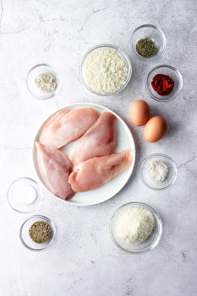 ingredients for panko crusted chicken on grey background