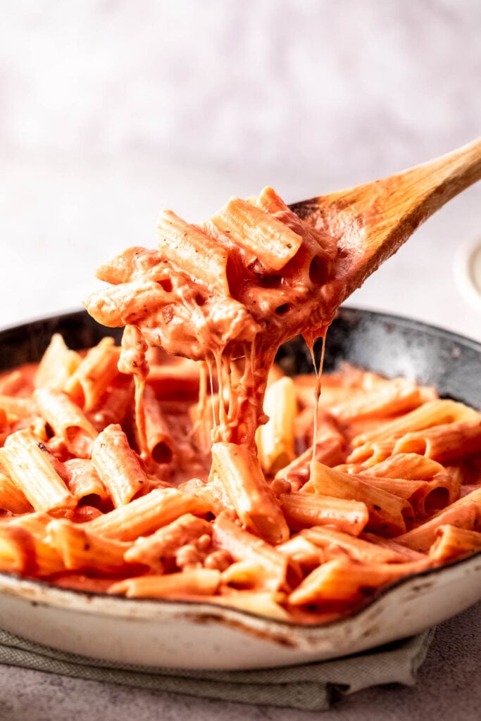 pink sauce pasta with cheese in white skillet