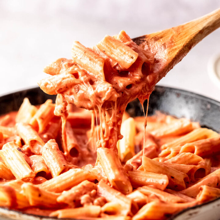 pink sauce pasta with cheese in white skillet