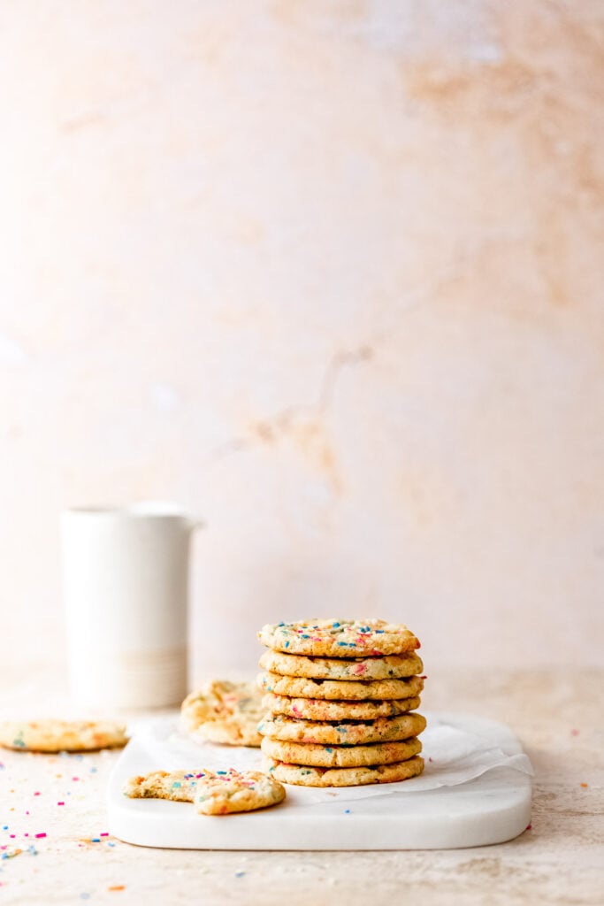 sprinkle cookies stacked with milk jug