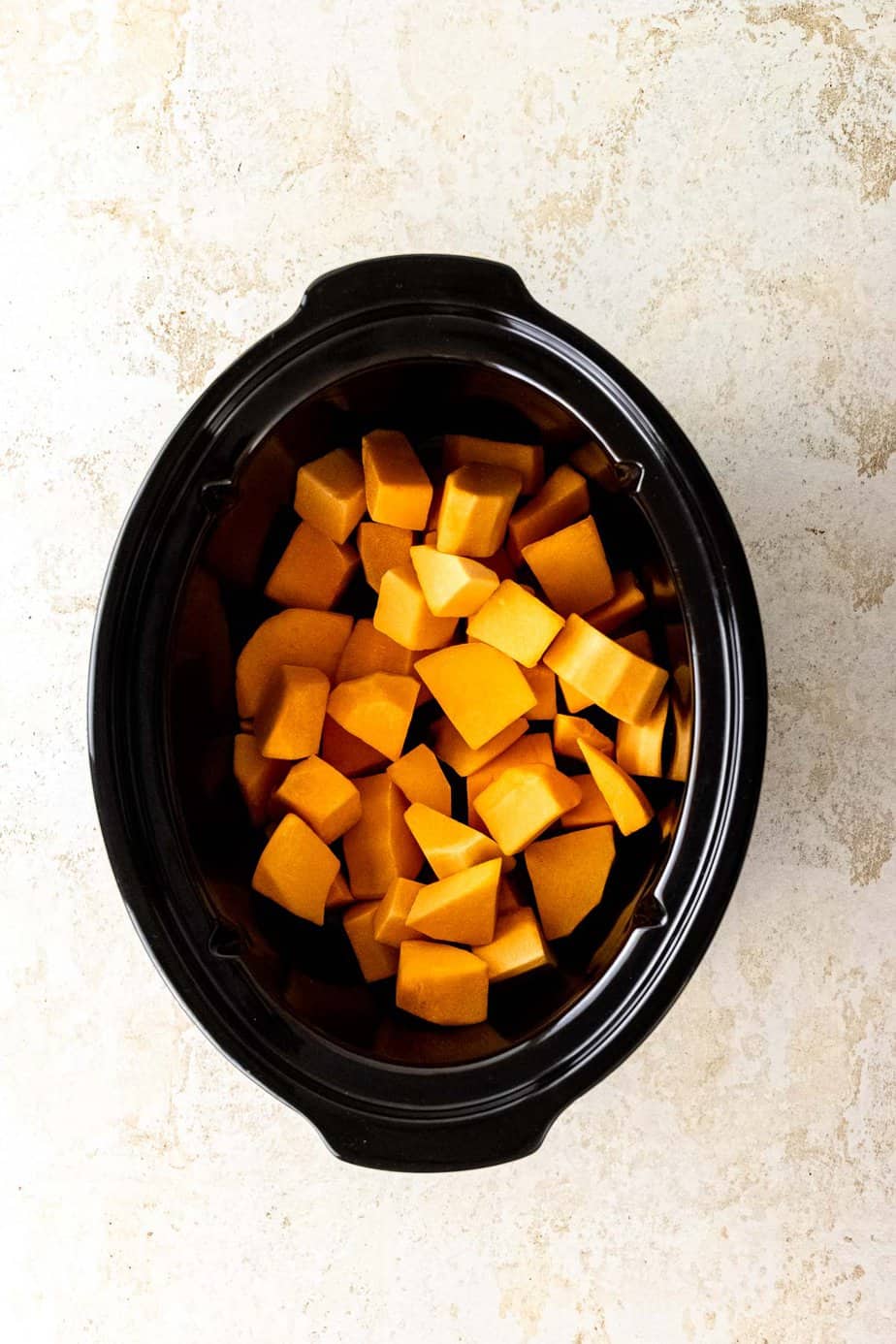 Pumpkin chunks in a slow cooker.