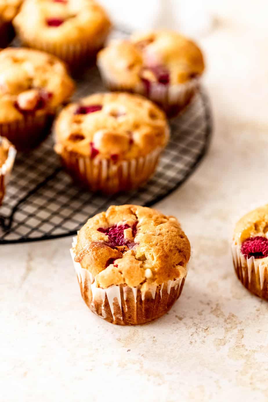 Raspberry and white chocolate muffins in a paper liner.