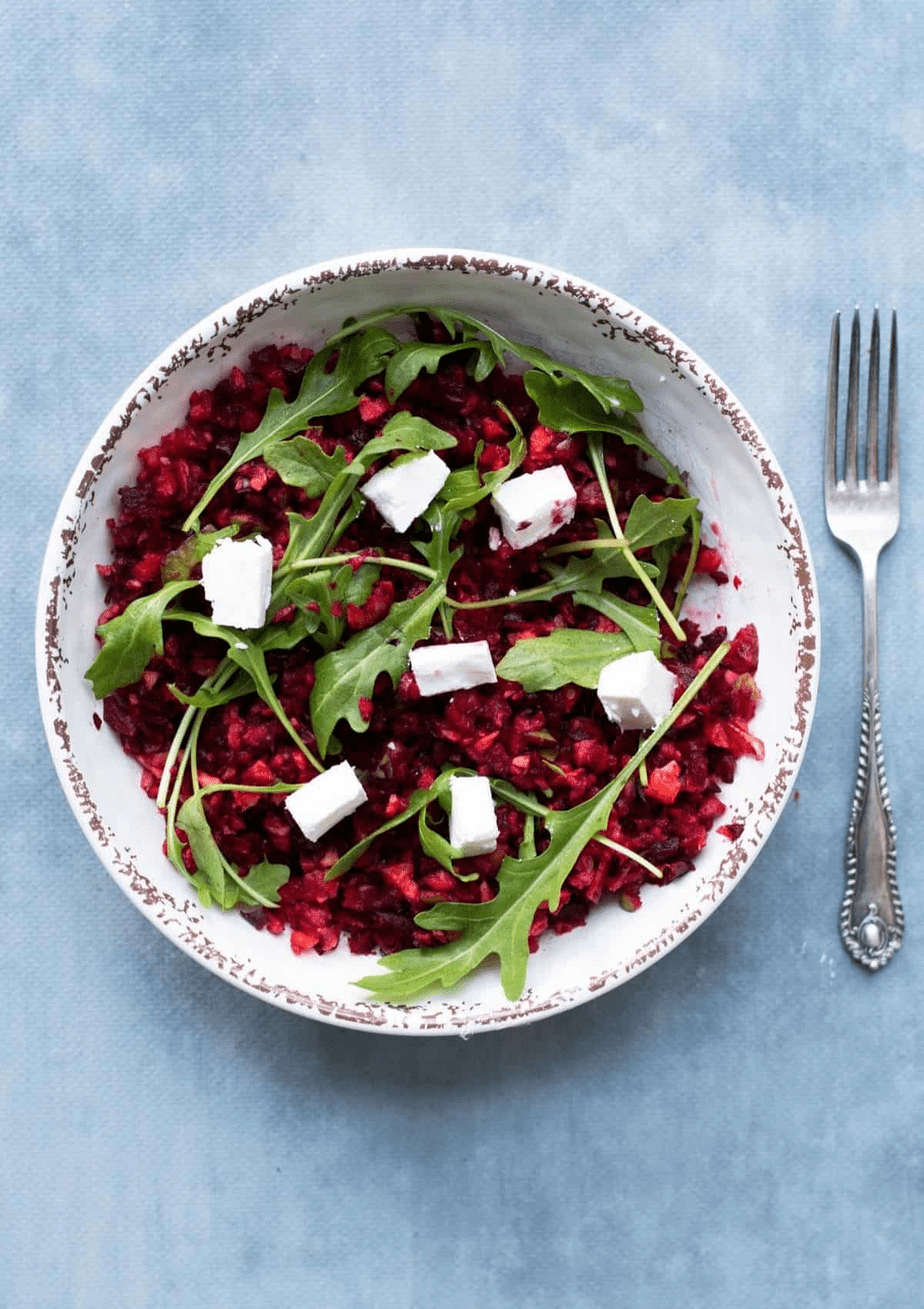 Beetroot salad with feta on a blue background.