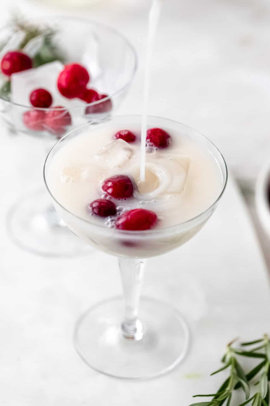 A christmas cocktail with fresh cranberries.