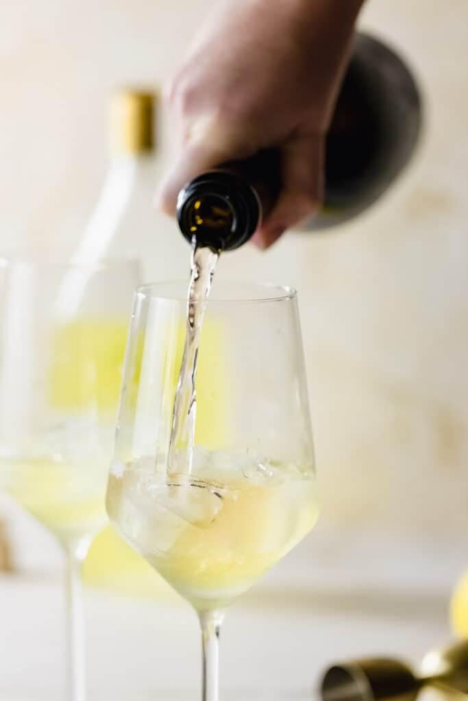 prosecco pouring into wine glasses