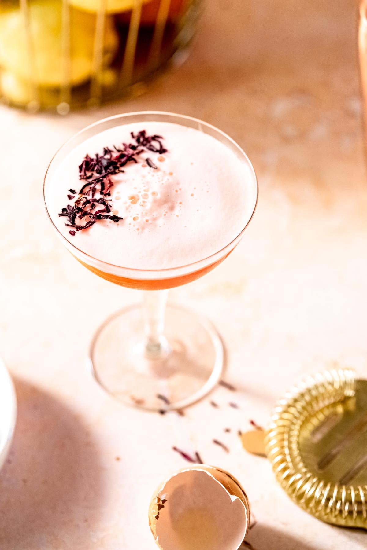 pink background with aperol cocktail and egg white foam