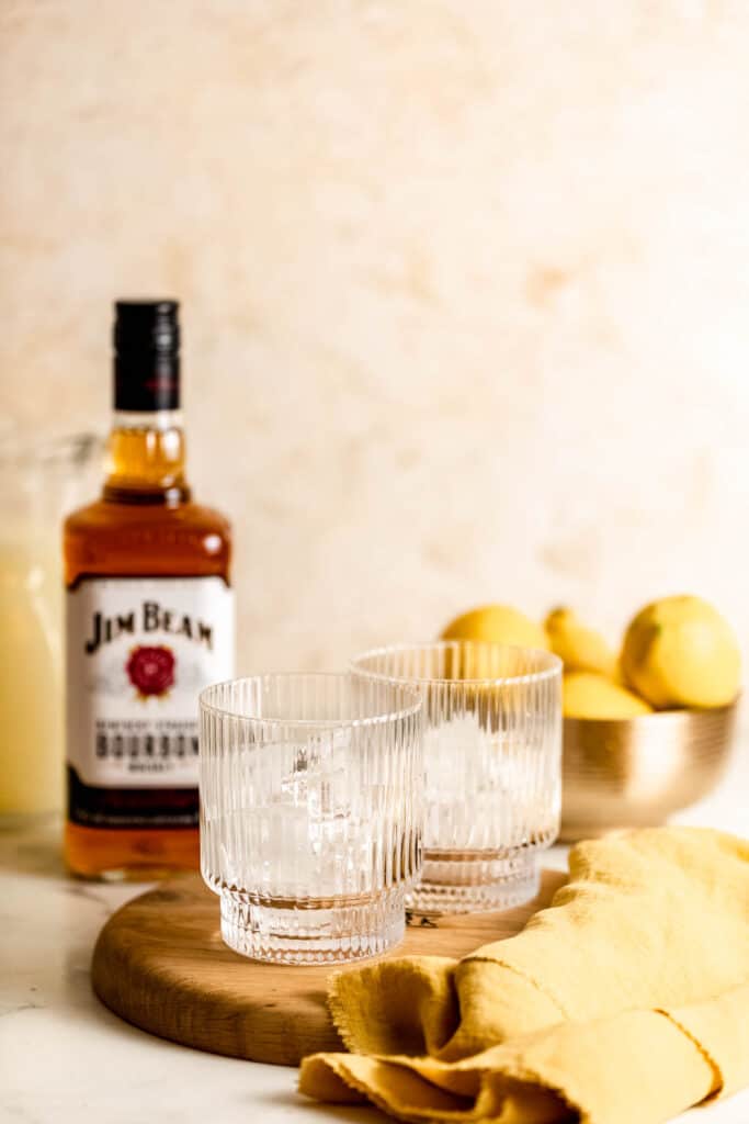 ice in rippled glasses with jim beam bourbon bottle in background