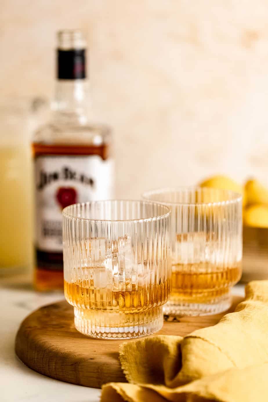 Straight whiskey over ice in two serving glasses