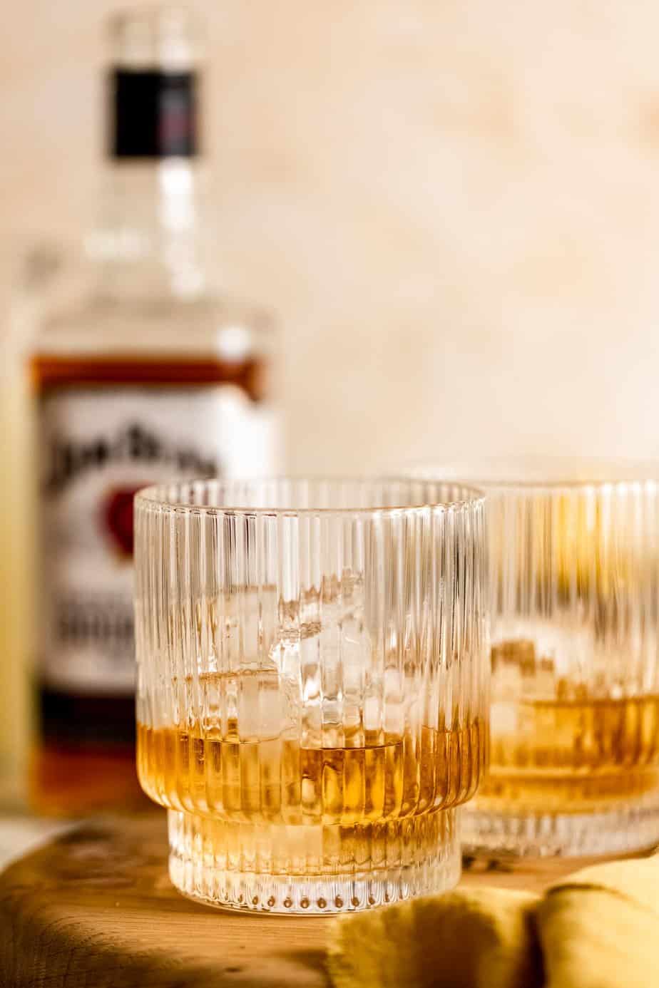 dark whiskey in glass over ice