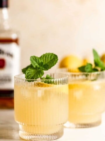 bourbon lemonade in wide ribbed glasses with fresh mint