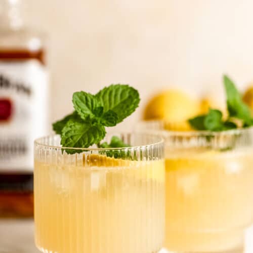 bourbon lemonade in wide ribbed glasses with fresh mint