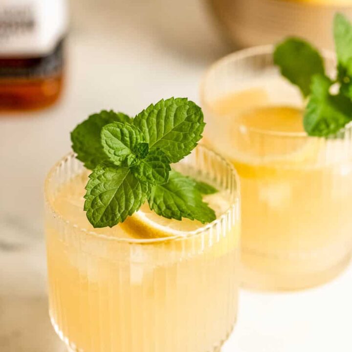 glass of lemonade and bourbon topped with fresh mint sprig