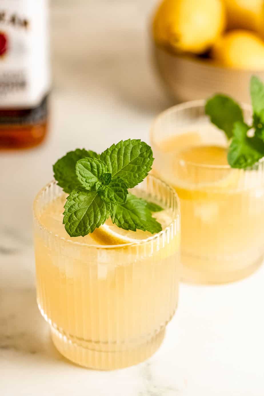 glass of lemonade and bourbon topped with fresh mint sprig