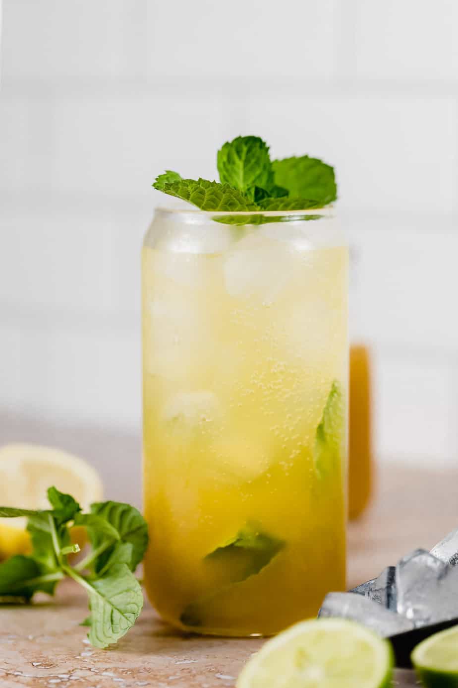 tall glass with mango mojito topped with club soda and fresh mint