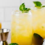 two glasses with mango mojito and fresh mint