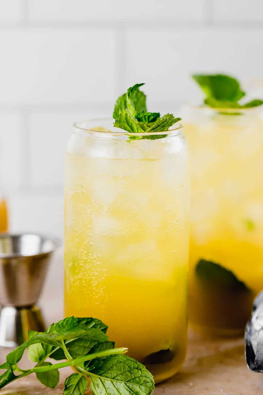 two glasses with mango mojito and fresh mint