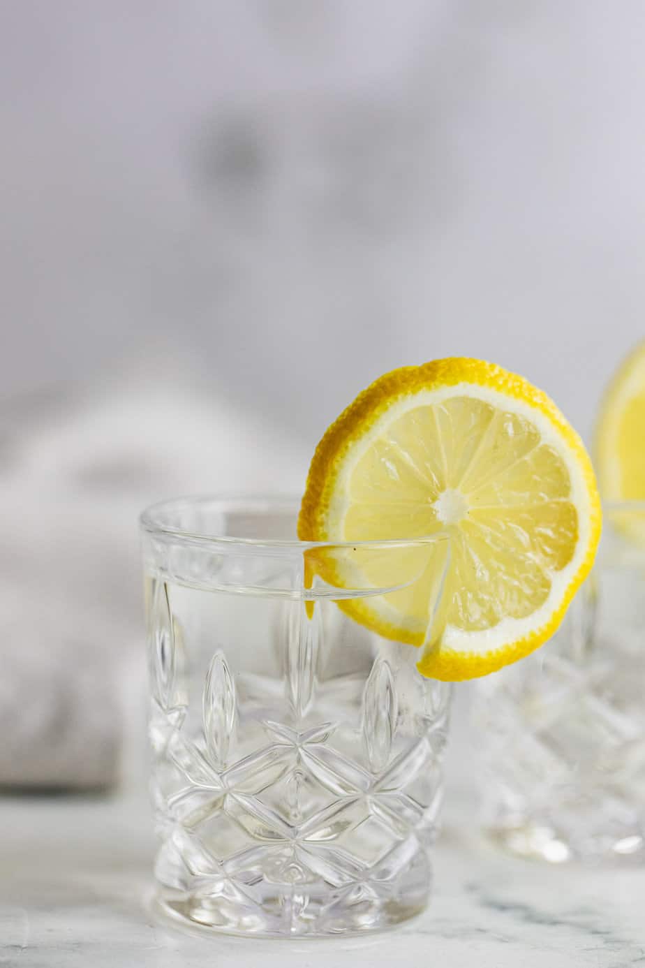 A vodka shot with fresh lemon slice.